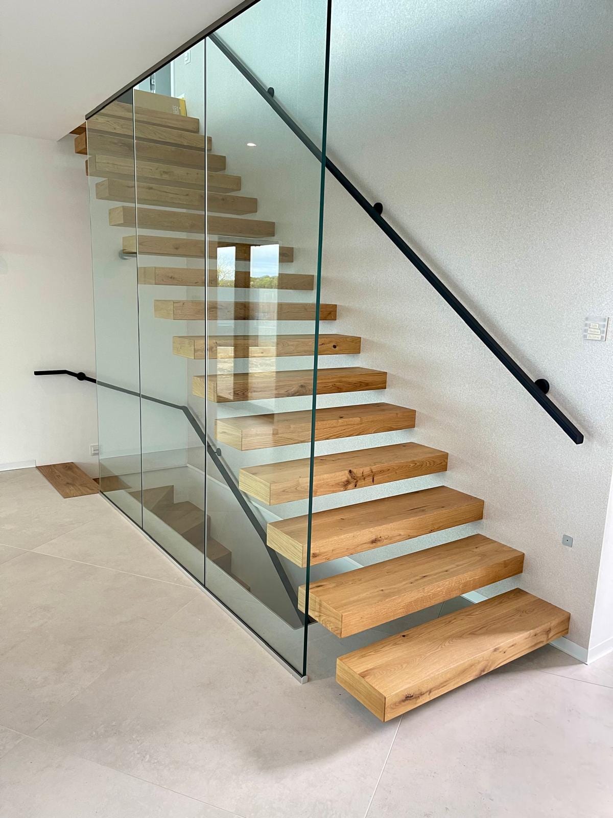 Kragarmtreppe Eiche mit Ganzglaswand und Wandhandlauf – AN Treppenbau